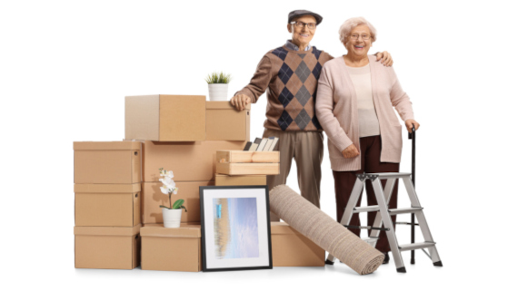 retired couple standing next to belongings